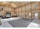 Spacious barn interior featuring a basketball court, storage, and ample natural light at 8820 Mud Creek Rd, Indianapolis, IN 46256