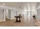 Spacious basement featuring plank flooring, a game table, and bright lighting, perfect for entertaining or hobbies at 8820 Mud Creek Rd, Indianapolis, IN 46256