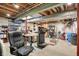 Unfinished basement features open ceiling, storage shelves, and ample space for workshop and recreation at 8820 Mud Creek Rd, Indianapolis, IN 46256