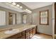 Full bathroom featuring double sinks, two windows for natural light, and plenty of counter space at 8820 Mud Creek Rd, Indianapolis, IN 46256
