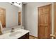 Bathroom featuring a modern vanity with sleek faucet and a framed mirror over a dark wood cabinet at 8820 Mud Creek Rd, Indianapolis, IN 46256