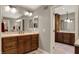 Bathroom with a double vanity and mirrors, cabinets, and neutral-colored flooring at 8820 Mud Creek Rd, Indianapolis, IN 46256