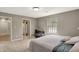Neutral bedroom boasts a seating area, view, and an ensuite bathroom for added privacy and convenience at 8820 Mud Creek Rd, Indianapolis, IN 46256