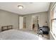 Comfortable bedroom includes access to a bathroom, neutral decor, and natural light from a window at 8820 Mud Creek Rd, Indianapolis, IN 46256