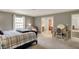 Bedroom features a comfortable bed, a desk, and natural light from the windows at 8820 Mud Creek Rd, Indianapolis, IN 46256