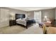 Cozy bedroom featuring a large bed, neutral carpet, and natural light from a window at 8820 Mud Creek Rd, Indianapolis, IN 46256
