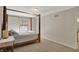 Bedroom featuring a 4-poster bed, soft carpet, and natural light from a window at 8820 Mud Creek Rd, Indianapolis, IN 46256