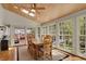 Sun-drenched dining room with vaulted wood ceilings, skylights, and walls of large windows at 8820 Mud Creek Rd, Indianapolis, IN 46256