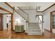 Grand foyer showcasing a staircase, hardwood floors, and elegant trim at 8820 Mud Creek Rd, Indianapolis, IN 46256