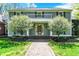 Inviting front entrance featuring a brick path, beautiful trees, and manicured lawn at 8820 Mud Creek Rd, Indianapolis, IN 46256