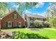 Charming exterior with well-manicured lawn, mature trees, brick and vinyl siding at 8820 Mud Creek Rd, Indianapolis, IN 46256