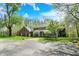 Charming exterior view of a two-story home, lush lawn, and mature trees at 8820 Mud Creek Rd, Indianapolis, IN 46256