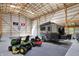 The large garage space has ample storage, with a trailer, yard equipment, and recreational vehicles at 8820 Mud Creek Rd, Indianapolis, IN 46256