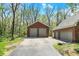Detached three car garage with brick exterior and traditional overhead doors at 8820 Mud Creek Rd, Indianapolis, IN 46256