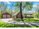 A detached three car garage accompanies this charming brick and vinyl sided home at 8820 Mud Creek Rd, Indianapolis, IN 46256