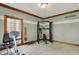 Home gym featuring an elliptical machine, weight machine and free weights and views of outside at 8820 Mud Creek Rd, Indianapolis, IN 46256