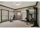 Well equipped home gym with exercise machines and free weights and windows at 8820 Mud Creek Rd, Indianapolis, IN 46256