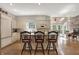 Kitchen with custom white cabinets, granite countertops, a center island with seating, hardwood floors, and ample natural light at 8820 Mud Creek Rd, Indianapolis, IN 46256