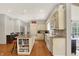 Spacious kitchen with granite counters, custom cabinets, hardwood floors and a center island with seating and built in shelves at 8820 Mud Creek Rd, Indianapolis, IN 46256