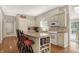 Charming kitchen features a center island, custom white cabinets, granite countertops and hardwood floors at 8820 Mud Creek Rd, Indianapolis, IN 46256