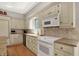Modern kitchen with stainless steel appliances, custom white cabinets, tile backsplash and granite countertops at 8820 Mud Creek Rd, Indianapolis, IN 46256