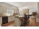 Well-appointed kitchen featuring granite countertops, custom white cabinets, hardwood floors, and a center island with seating at 8820 Mud Creek Rd, Indianapolis, IN 46256