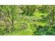 Lush land showcasing vibrant green trees, a well maintained lawn, and a picturesque walking trail through the property at 8820 Mud Creek Rd, Indianapolis, IN 46256