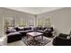 Comfortable living room showcasing a large sectional, multiple windows, and a patterned rug at 8820 Mud Creek Rd, Indianapolis, IN 46256