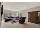 Spacious living room featuring a large sectional sofa, windows, and a built-in display case at 8820 Mud Creek Rd, Indianapolis, IN 46256