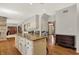 Open-concept living space with kitchen island, hardwood floors, and custom cabinetry creating a warm and inviting atmosphere at 8820 Mud Creek Rd, Indianapolis, IN 46256