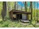Outbuilding is filled with equipment, perfect for hobbyists or ample storage, set among mature trees on a well-maintained lot at 8820 Mud Creek Rd, Indianapolis, IN 46256