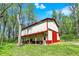 Exterior of outbuilding, featuring a red roof and ample green space around at 8820 Mud Creek Rd, Indianapolis, IN 46256