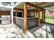Under-deck outdoor bar area with a stone counter and wooden supports, perfect for entertaining at 8820 Mud Creek Rd, Indianapolis, IN 46256