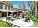 An outdoor patio boasts comfortable seating, a grill, and a bar, perfect for entertaining at 8820 Mud Creek Rd, Indianapolis, IN 46256