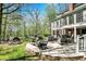Outdoor patio offers ample seating, a fire pit, and scenic views of the surrounding trees at 8820 Mud Creek Rd, Indianapolis, IN 46256