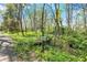 Street view of home with address marker in wooded, lush surroundings at 8820 Mud Creek Rd, Indianapolis, IN 46256