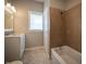 Well-lit bathroom with a tiled shower, a tub, modern vanity and ample natural light at 933 N 19Th N St, Elwood, IN 46036