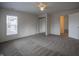 Spacious bedroom with neutral carpet, closet doors, and natural light from the window at 933 N 19Th N St, Elwood, IN 46036