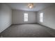 Spacious bedroom with neutral carpet, two windows, and ceiling fan for a bright and airy feel at 933 N 19Th N St, Elwood, IN 46036