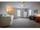 Bright bedroom featuring a bed with storage, a ceiling fan, and a cozy workspace with a desk at 933 N 19Th N St, Elwood, IN 46036
