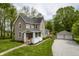 Charming two-story home featuring a well-manicured lawn and detached two-car garage at 933 N 19Th N St, Elwood, IN 46036