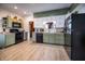 The bright kitchen features green cabinets, and modern appliances at 933 N 19Th N St, Elwood, IN 46036