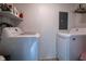 Functional laundry room with modern washer and dryer, overhead shelves, and ample space at 933 N 19Th N St, Elwood, IN 46036