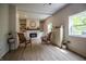 Bright living room featuring a fireplace, built-in shelves, and large windows at 933 N 19Th N St, Elwood, IN 46036
