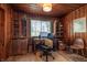 Wood-paneled office with built-in shelving, a large desk, and natural light from the window at 933 N 19Th N St, Elwood, IN 46036