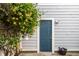 Charming backyard featuring a blue door, climbing vines, and a cozy outdoor space at 952 Elm St, Indianapolis, IN 46203