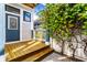 Inviting backyard featuring a wooden deck with steps, climbing vines, and a blue back door at 952 Elm St, Indianapolis, IN 46203