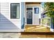 Inviting backyard featuring a wooden deck with steps, climbing vines, and a blue back door at 952 Elm St, Indianapolis, IN 46203