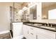 Modern bathroom with double vanity, granite countertops, and glass-enclosed shower at 952 Elm St, Indianapolis, IN 46203