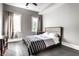 Modern bedroom with stylish decor, hardwood floors, and natural light streaming through the windows at 952 Elm St, Indianapolis, IN 46203